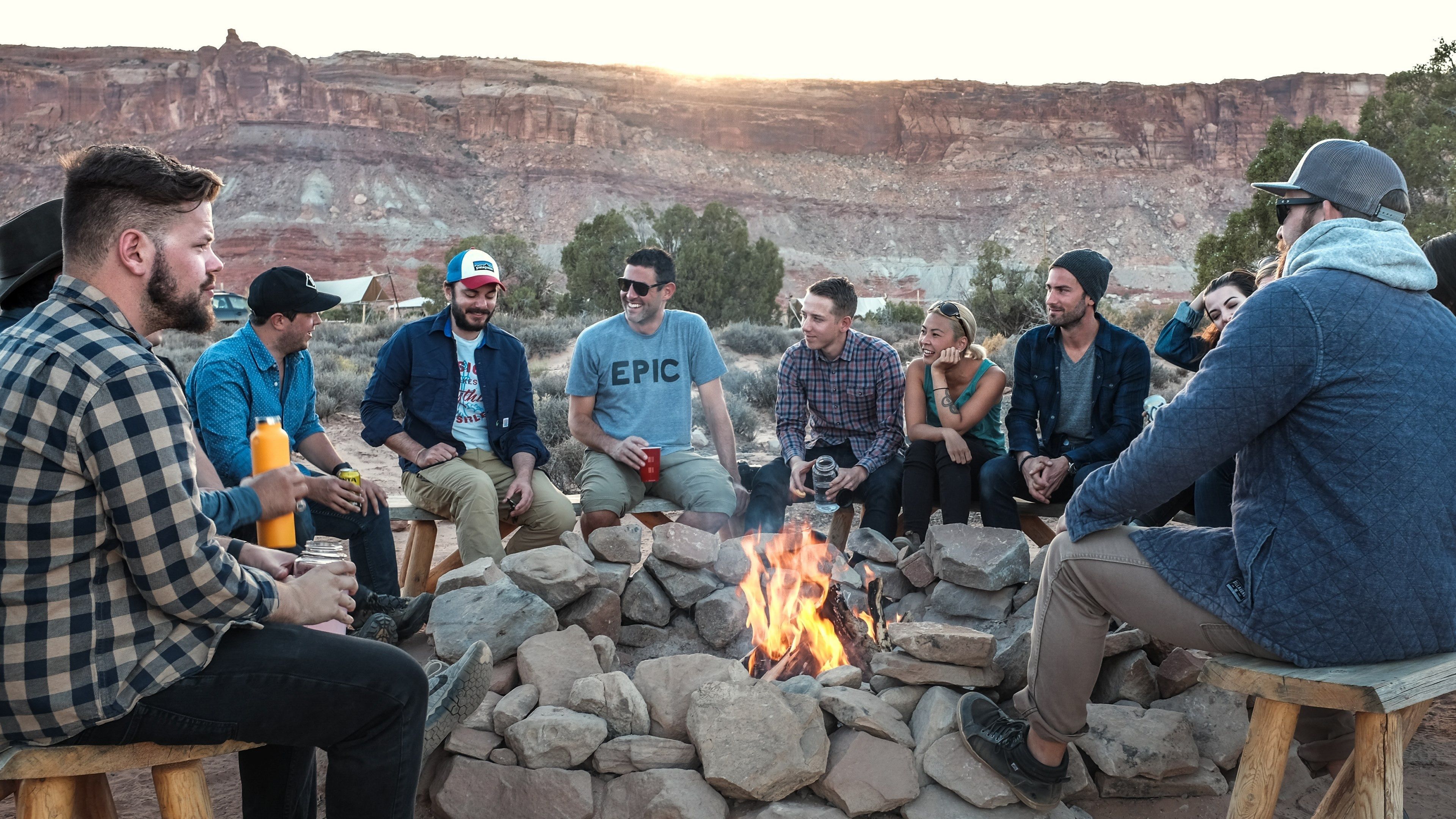 3840x2160 Wallpaper / a group of smiling young people sitting around a fire pit in the mountains, happy young people near fire 4k wallpaper free download
