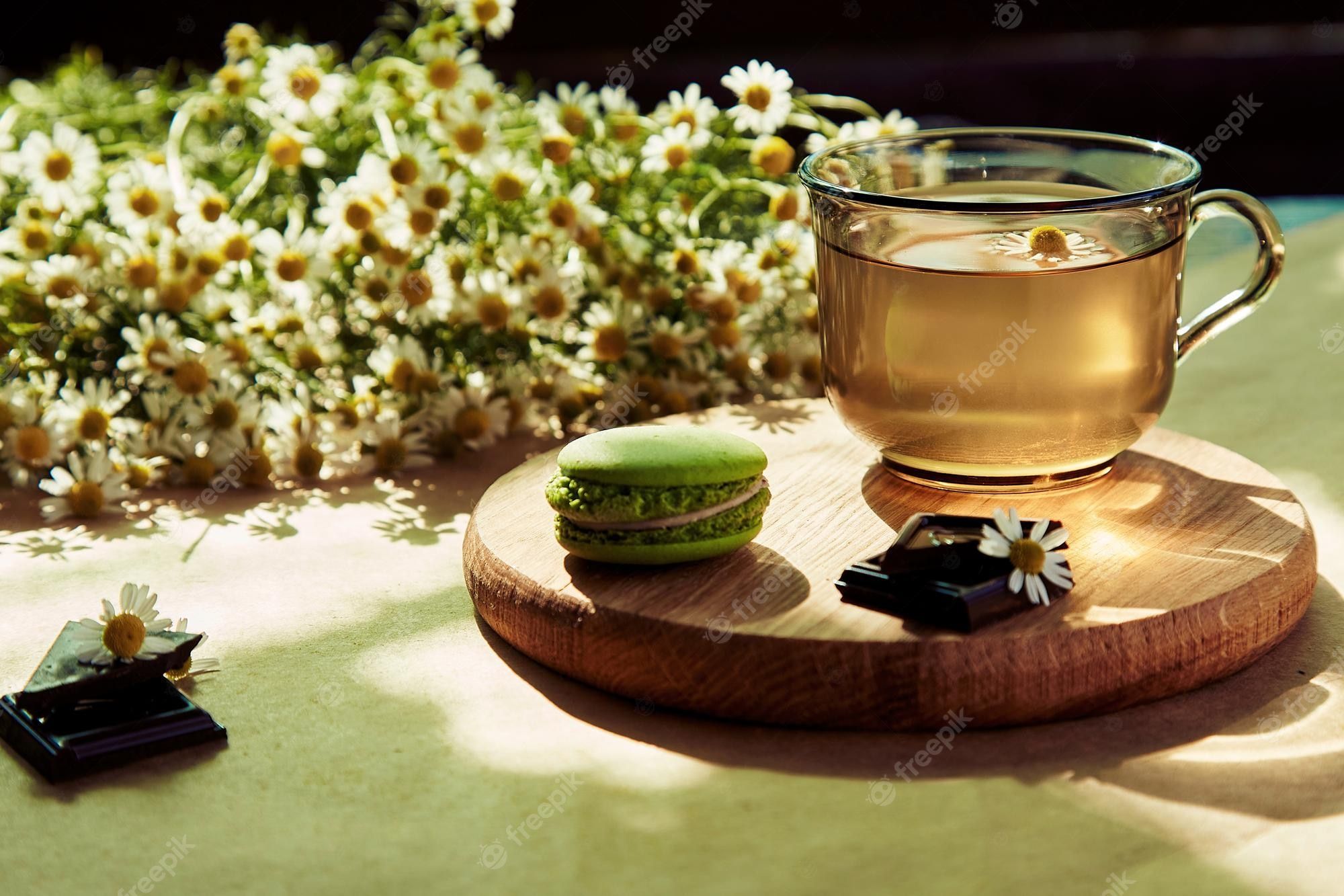 2000x1333 Premium Photo. Aesthetic summertime tea time herbal tea and macarons dessert outside in the terrace