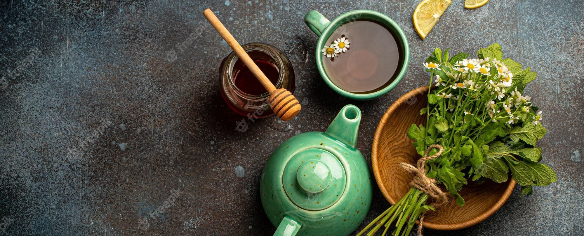 2000x811 Premium Photo. Herbal tea with natural healing medical herbs tea cup tea pot top view