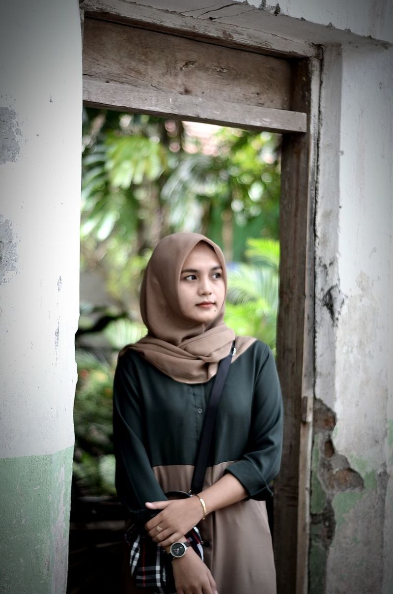 800x1208 Young woman in hijab looking away while