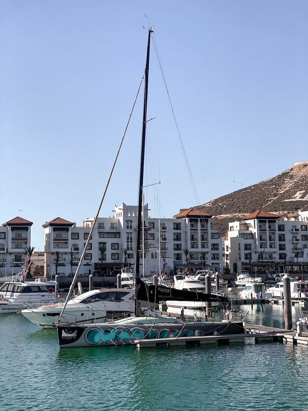 1000x1333 A sailboat in the water near a city photo