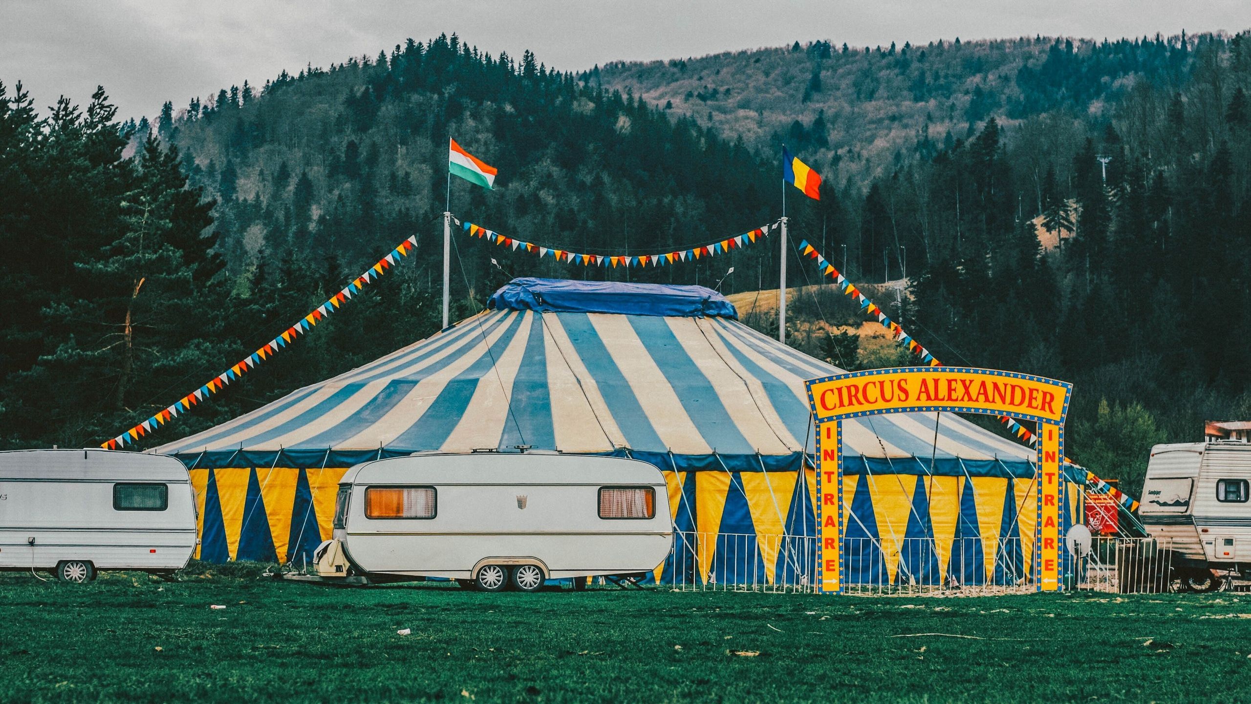 2560x1440 Wallpaper / caravans around a circus tent in the mountains, circus 4k wallpaper free download
