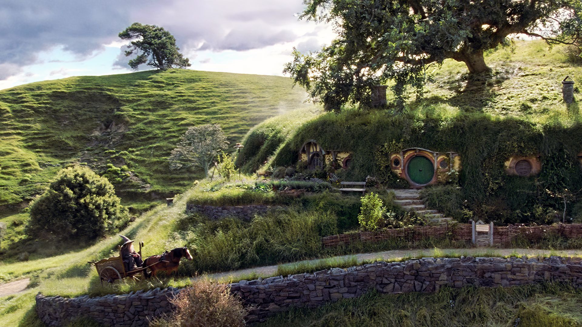 1920x1080 Gandalf, wizard, J. R. R. Tolkien, The Lord of the Rings: The Fellowship of the Ring, The Shire, Bag End, hills, trees, house, horse, carriage, movies, film stills, clouds, sky, stone fence