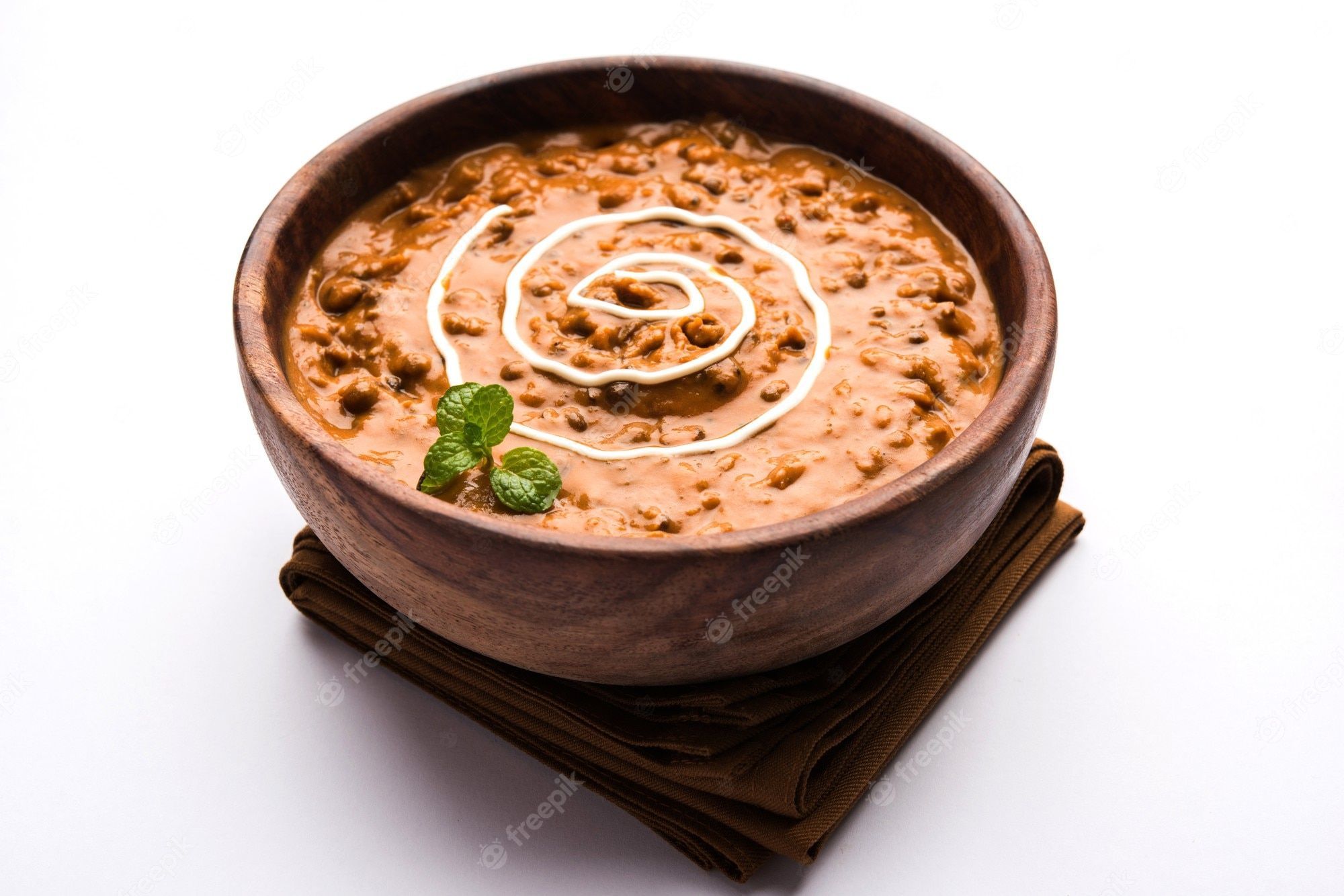 2000x1334 Premium Photo. Dal makhani or daal makhni is a popular food from punjab, india made using whole black lentil, red kidney beans, butter and cream and served with garlic naan or