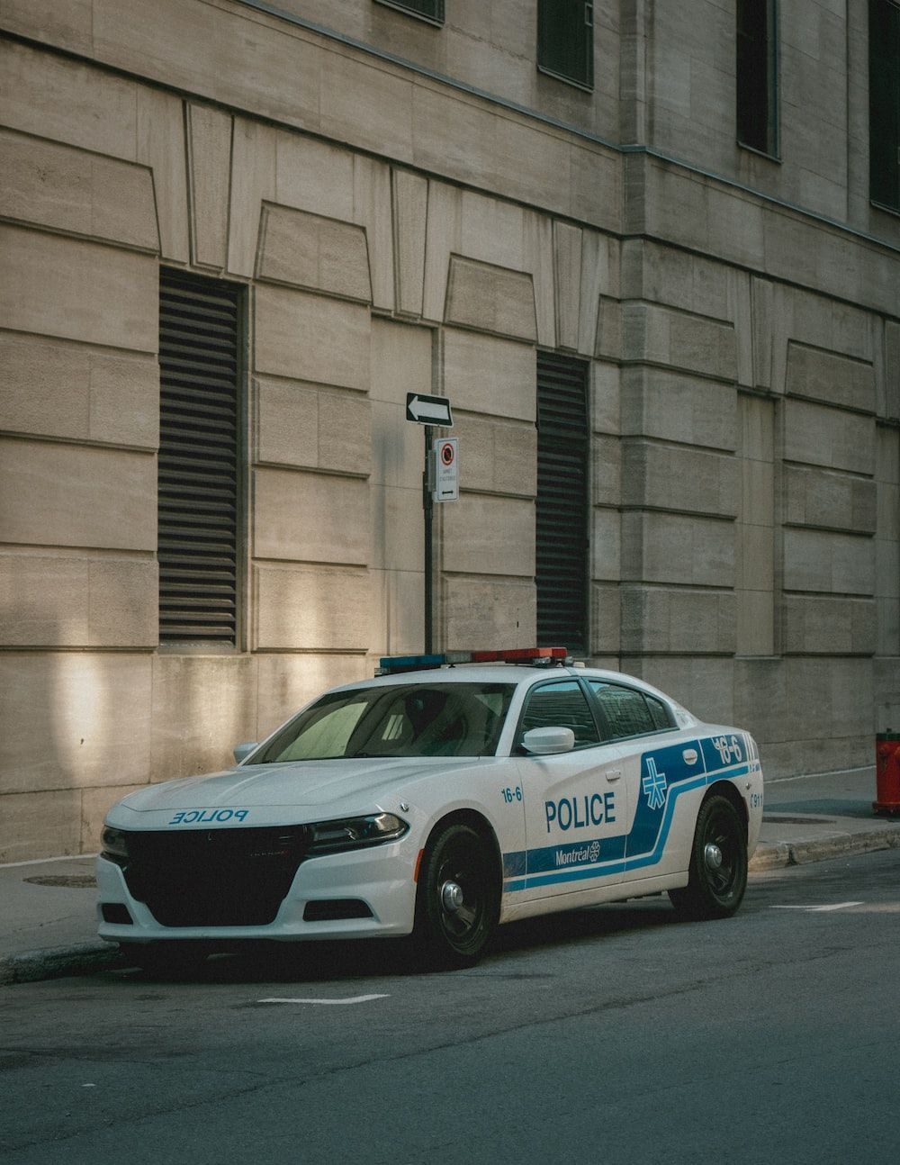 1000x1294 White and black police car parked beside black car during daytime photo