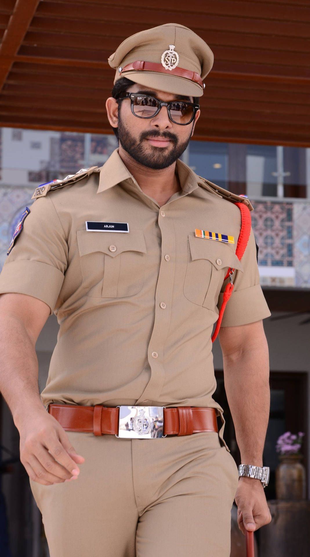 1069x1920 Download Allu Arjun In Brown Police Uniform Wallpaper