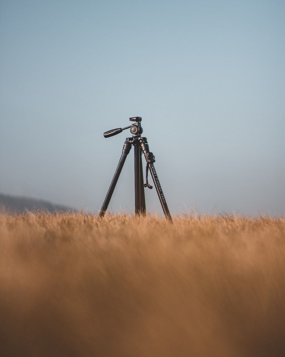 1000x1250 Black camera on tripod on brown grass field during daytime photo