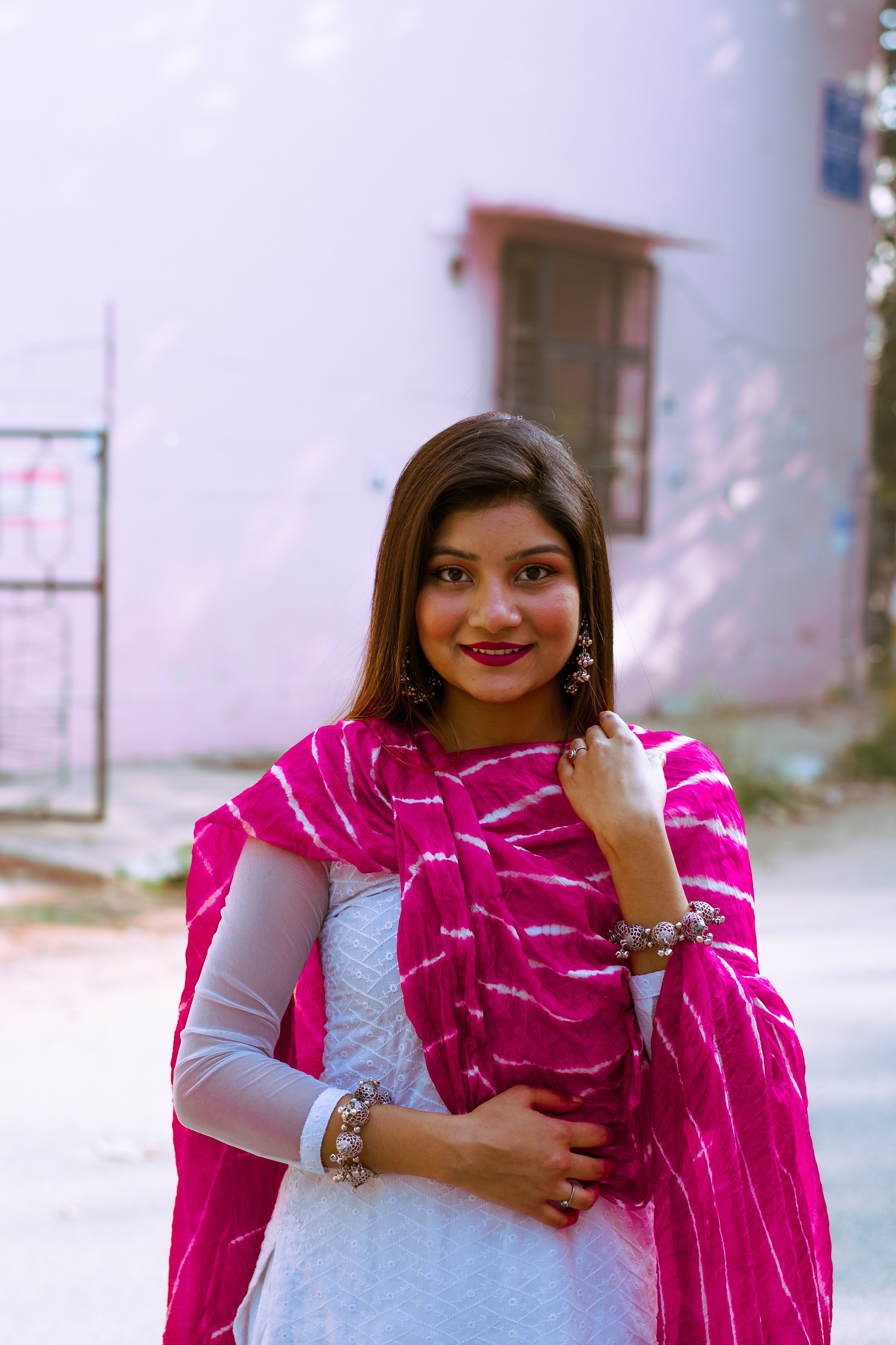 3712x5568 Woman Smiling Wearing a White Dress with Pink Scarf · Free