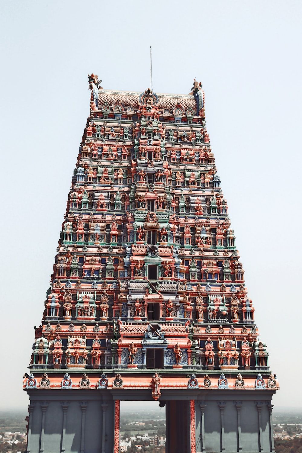1000x1500 A very tall building with a lot of statues on top of it photo