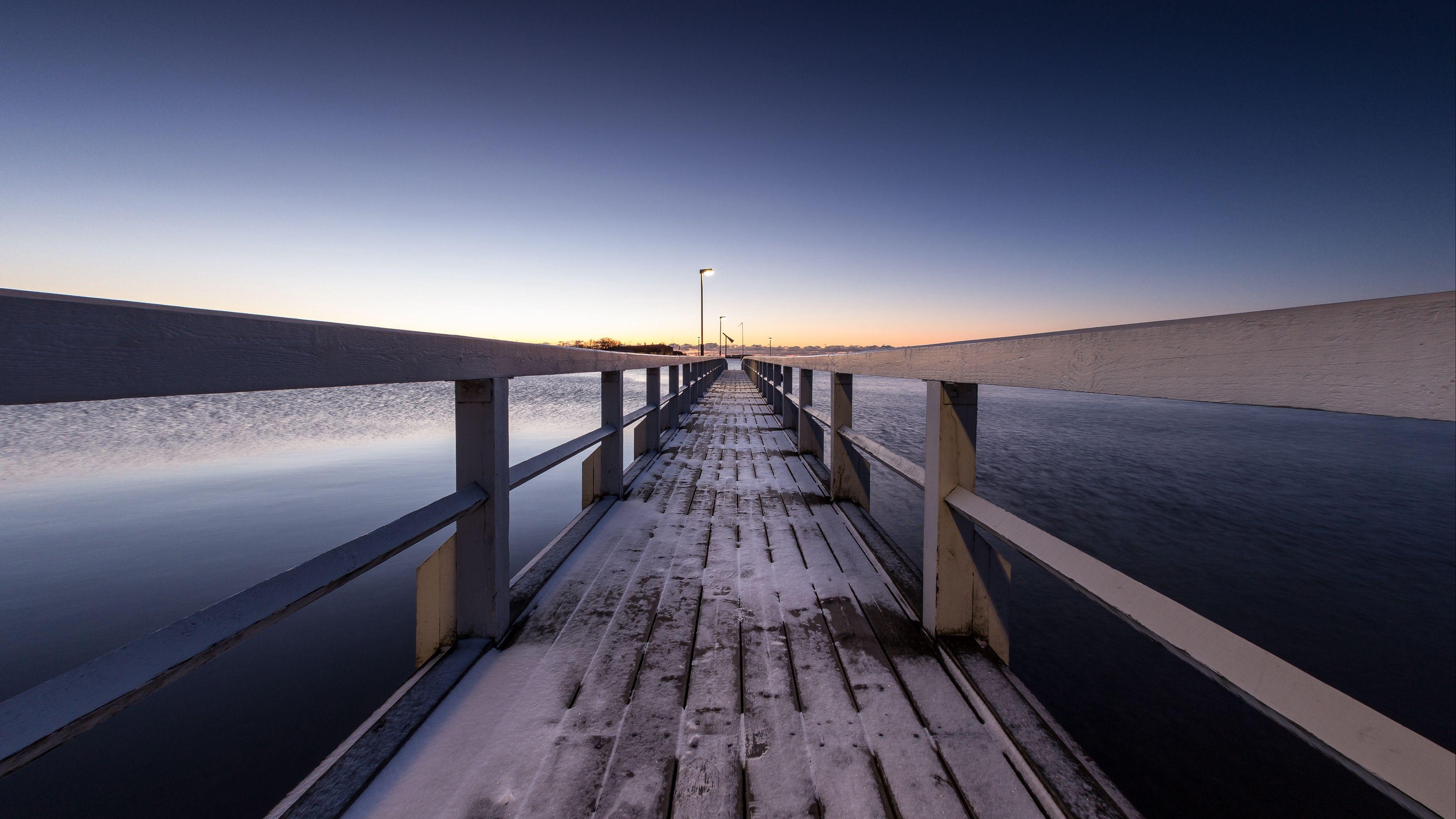 3840x2160 Download wallpaper 3840x2160 pier, snow, bridge, sunset, helsinki