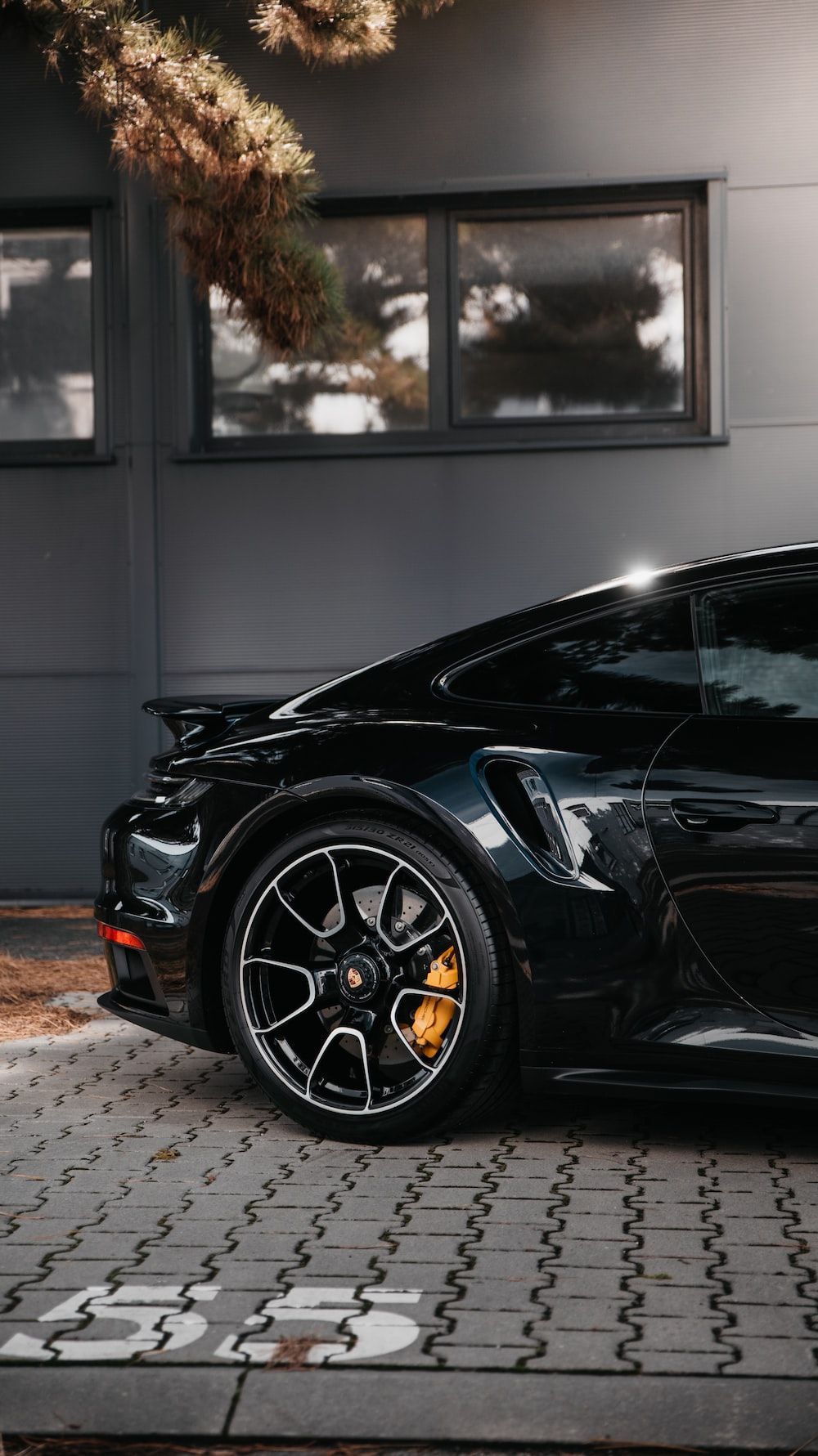 1000x1781 Black porsche 911 parked on gray pavement photo