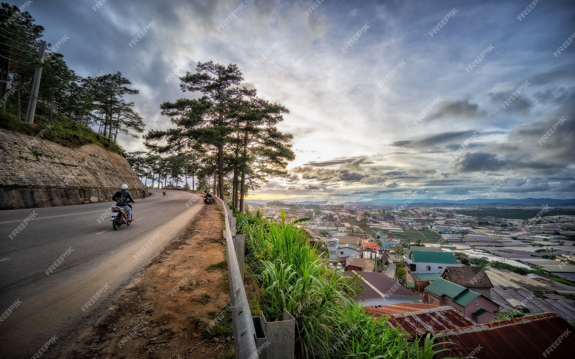 2000x1250 Premium Photo. The beautiful landscape of road and village during sunrise and sunset