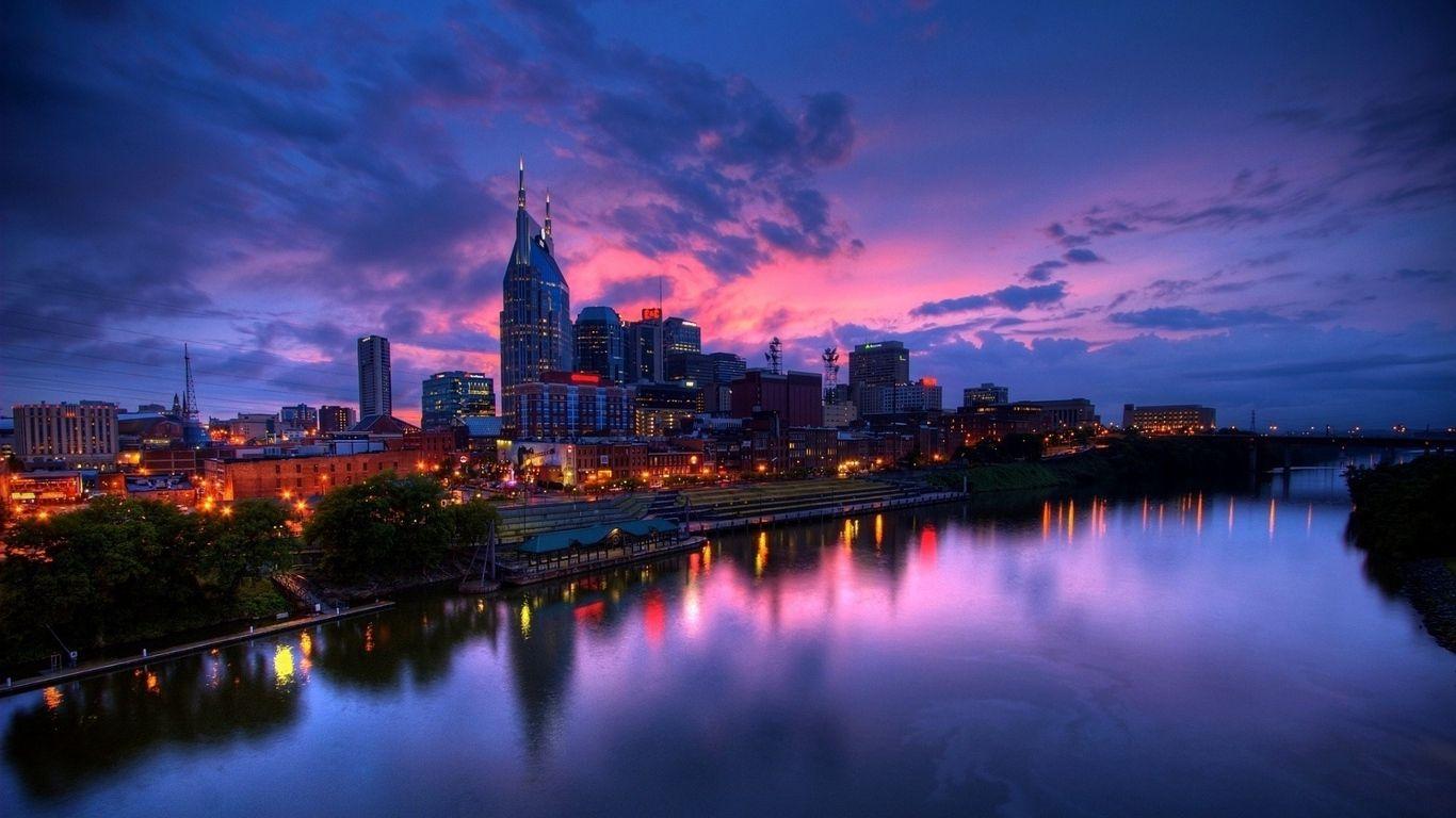 1366x768 Download wallpaper 1366x768 purple sunset, city, buildings