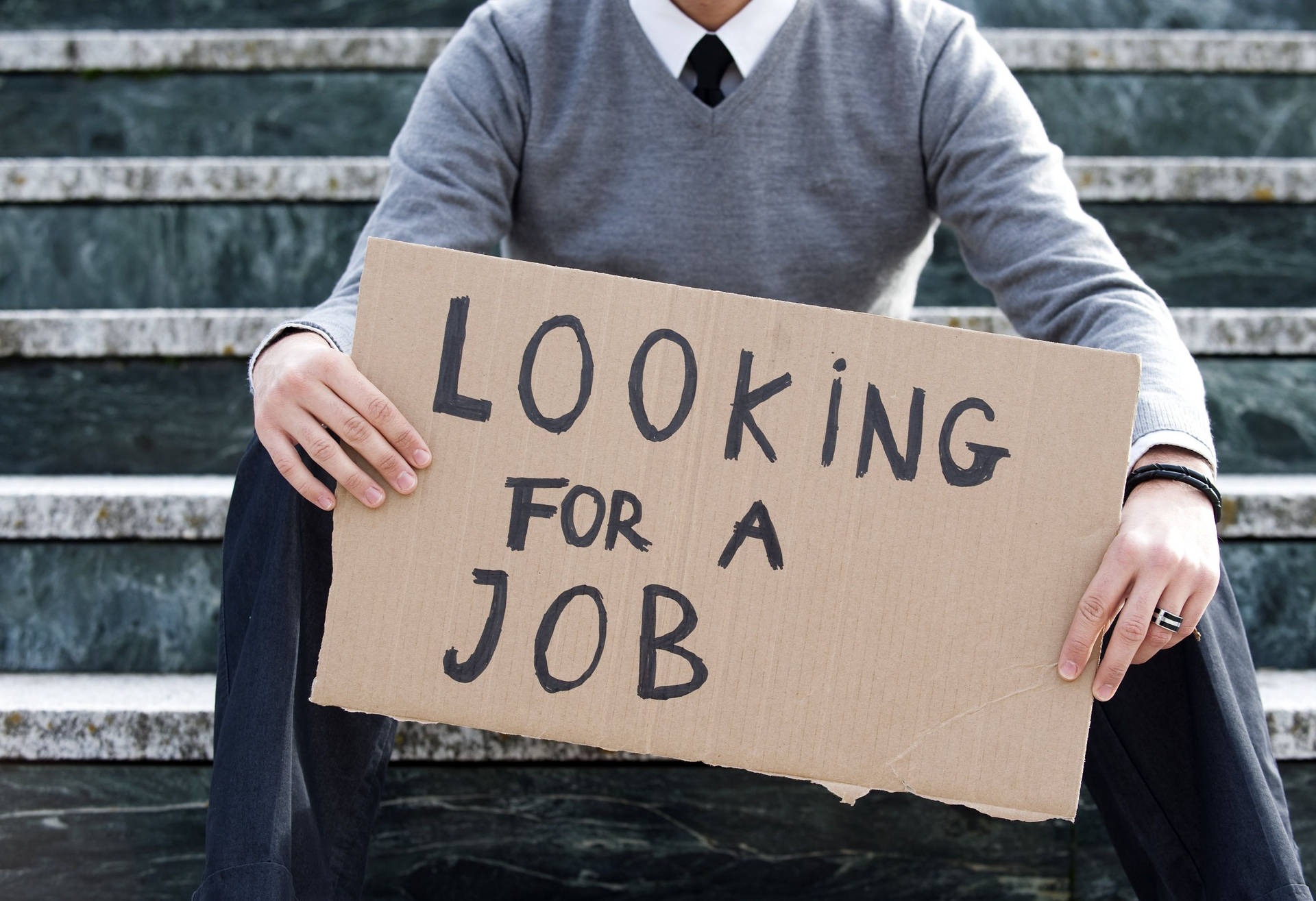 1920x1315 Download Man Holding Signage Related To Unemployment Wallpaper