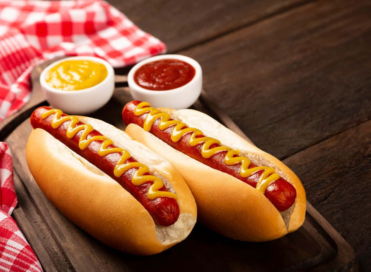 1200x879 Download Two Hot Dogs With Mustard And Ketchup On A Wooden Board