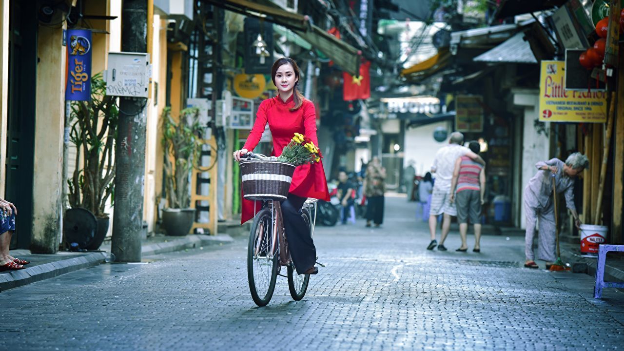 1280x720 Picture Brunette girl blurred background Bicycle young woman moving