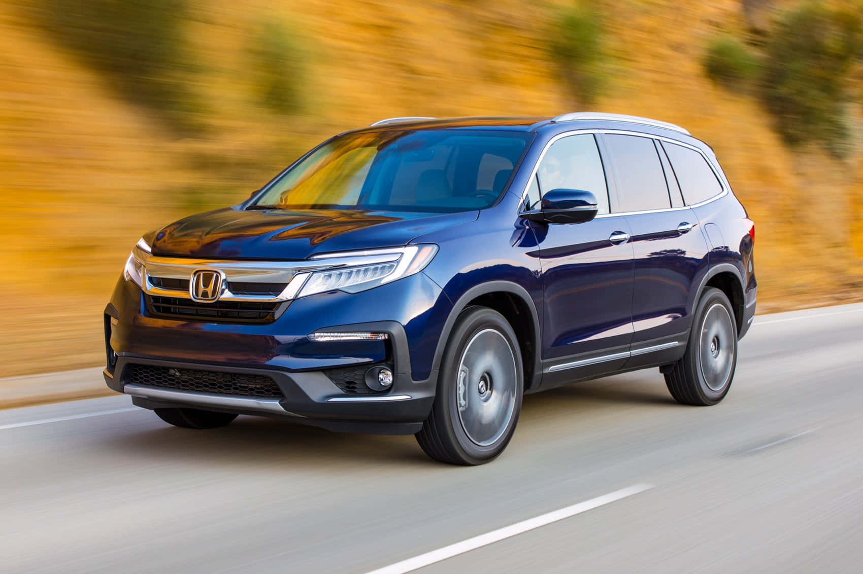 1700x1132 Download Sleek and Spacious Honda Pilot on the Road Wallpaper
