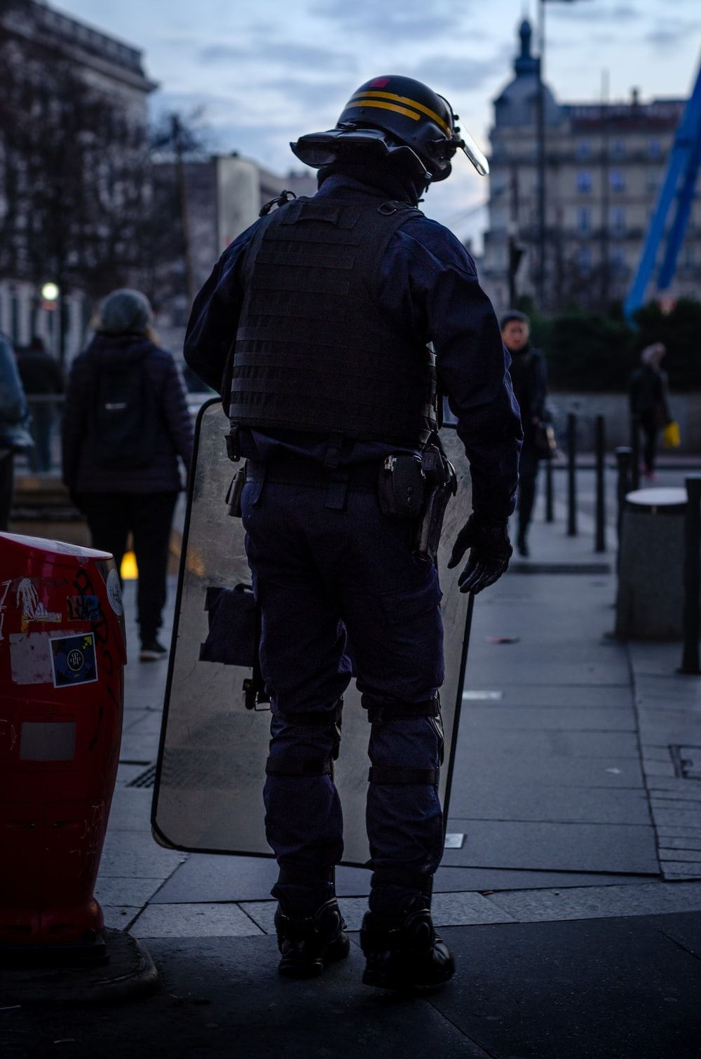 1000x1510 Police officer standing and carrying riot shield photo