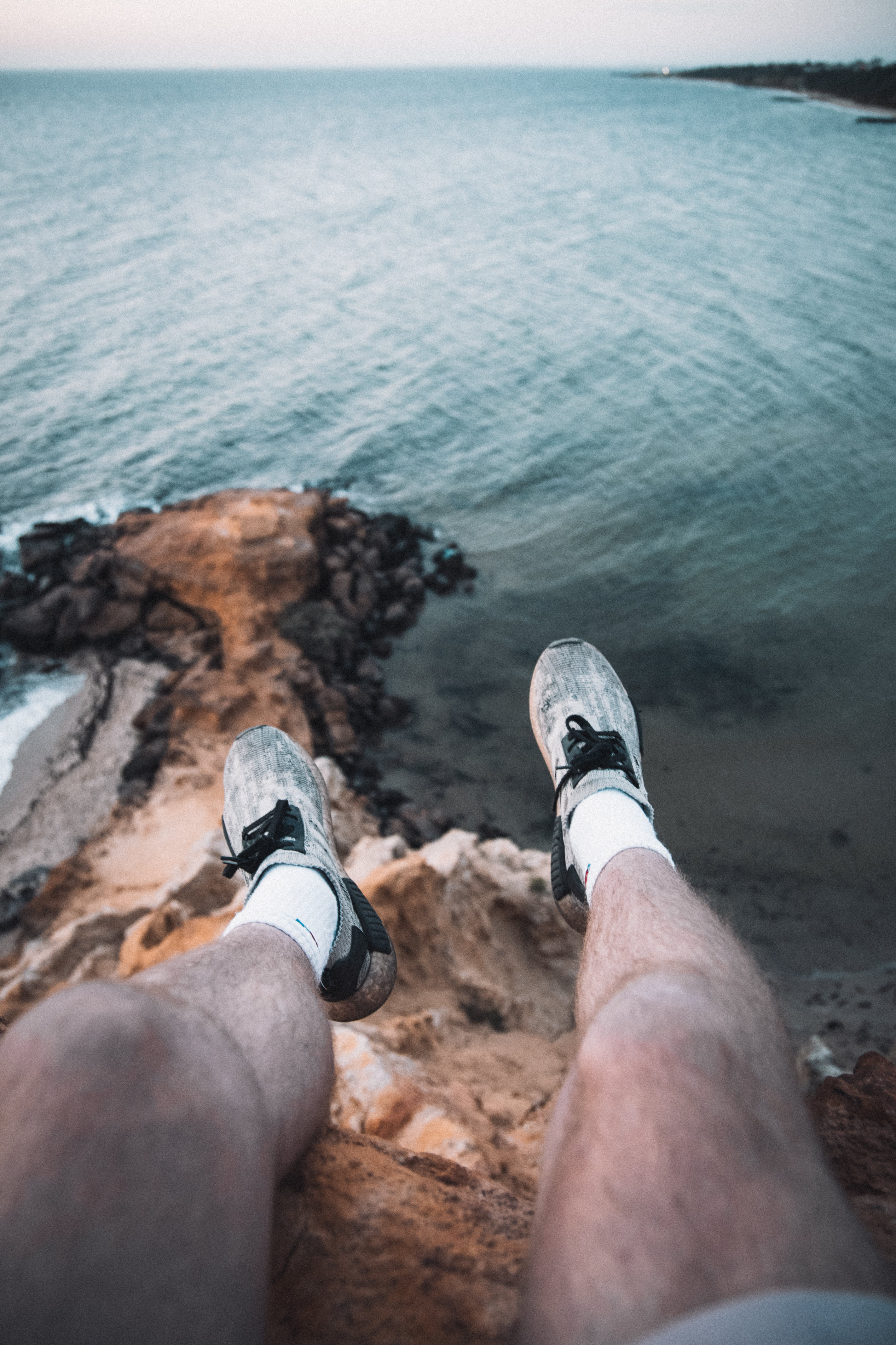 4325x6488 The Point of View of a Person Sitting on a Cliff with a View of a City · Free