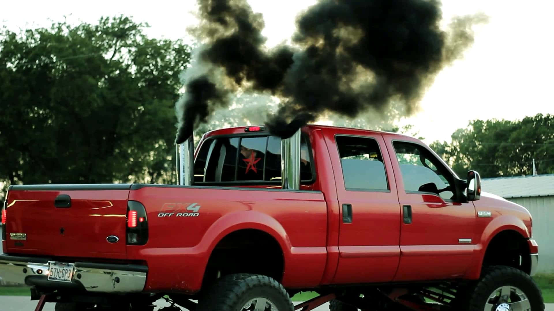 1920x1080 Download A Red Truck With Black Smoke Coming Out Of The Back Wallpaper