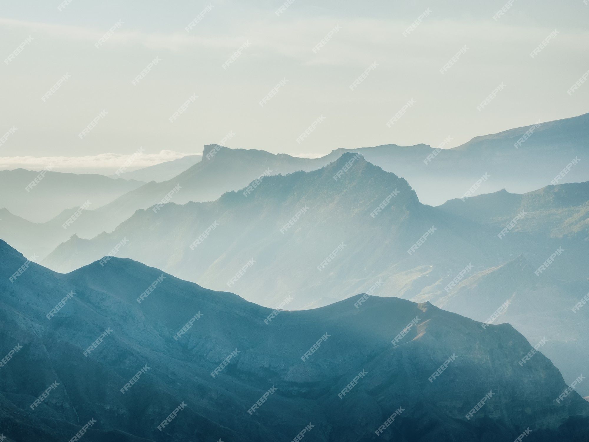 2000x1500 Premium Photo. Soft focus. silhouette of the caucasus mountains. foggy layered mountain landscape