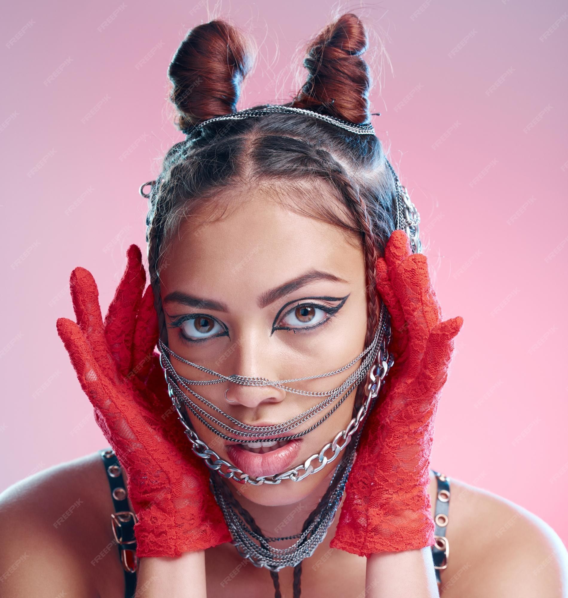 1900x2000 Premium Photo. Chains fashion and face of goth woman with unique style isolated against a studio pink background portrait accessories and edgy female model metal jewelry on her head and cool