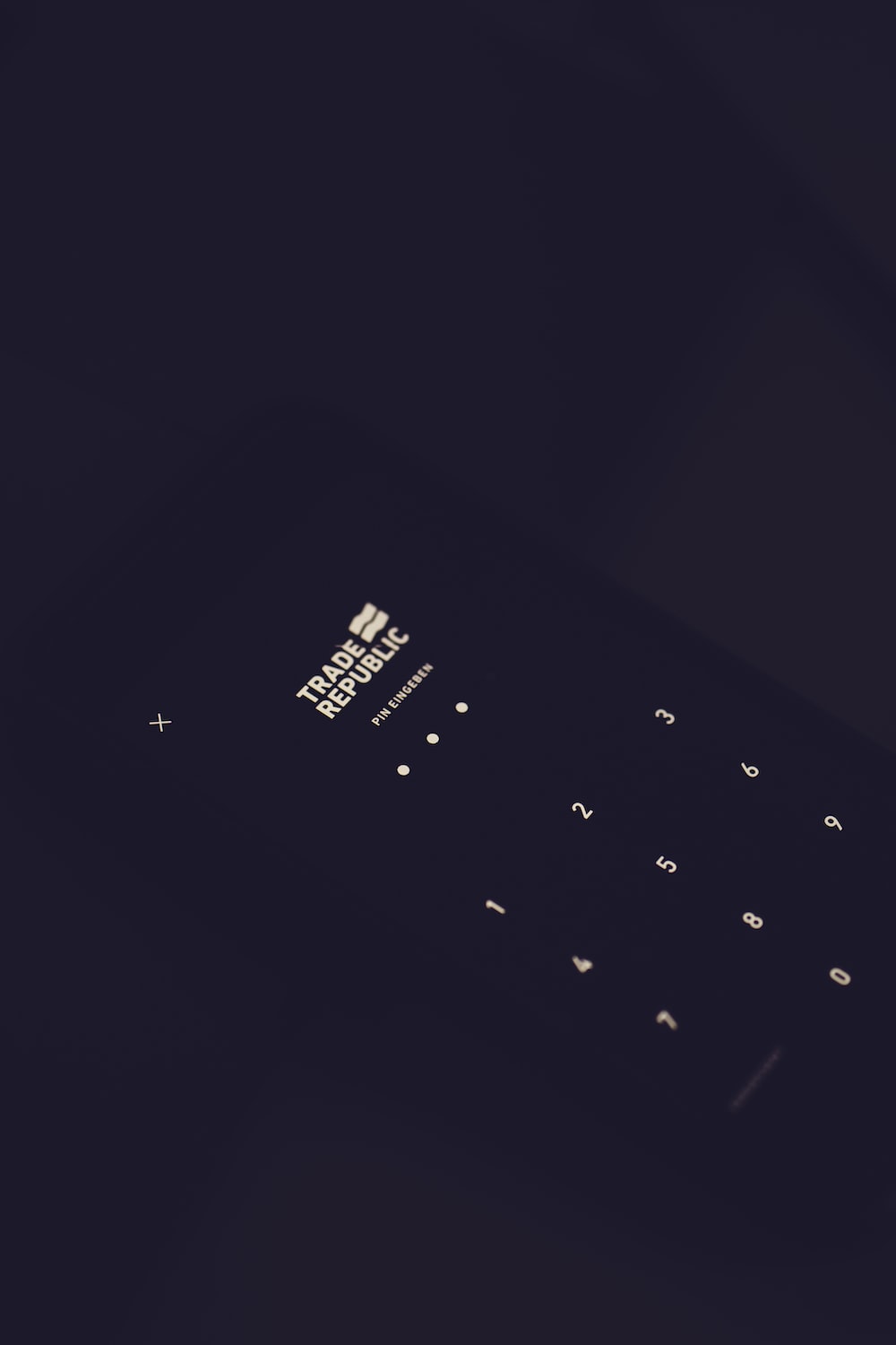 1000x1500 Black qwerty phone on black textile photo