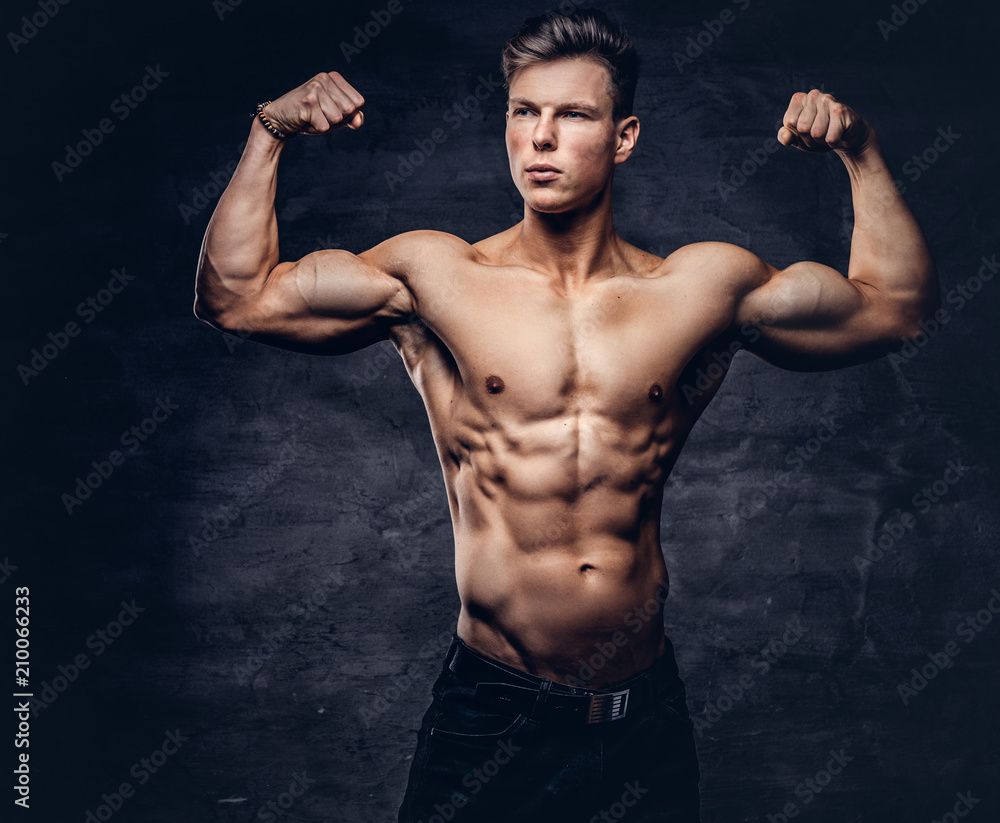 1000x823 Beautiful shirtless young man model with nice muscular body posing at a studio