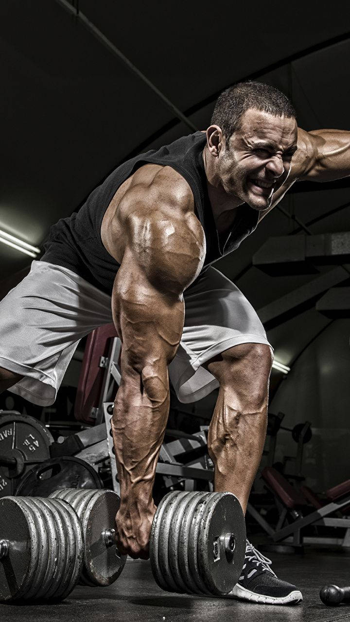 720x1280 Download Bodybuilder Carrying Dumbbell HD Wallpaper