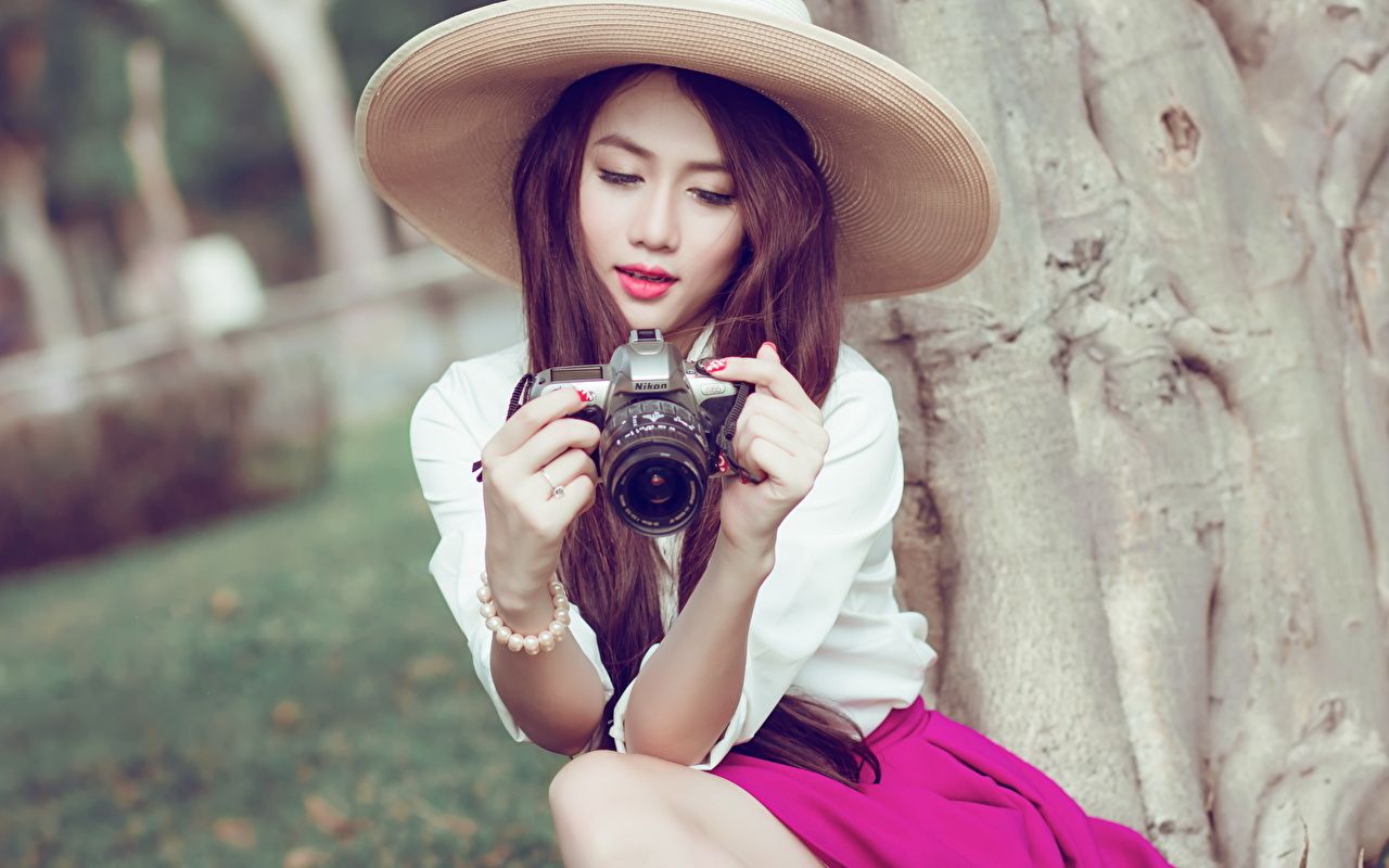 1280x800 Photo Brown haired Camera Photographer Hat Girls Asian sit Hands