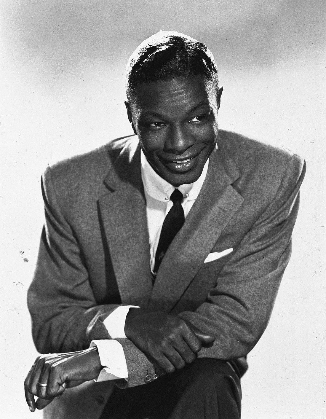 1100x1413 Download Legendary Singer Nat King Cole in a Pensive Pose Wallpaper