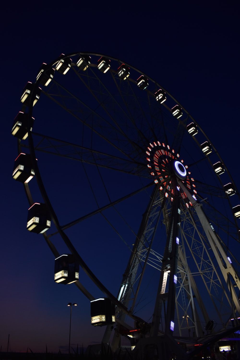1000x1500 A large ferris wheel lit up at night photo