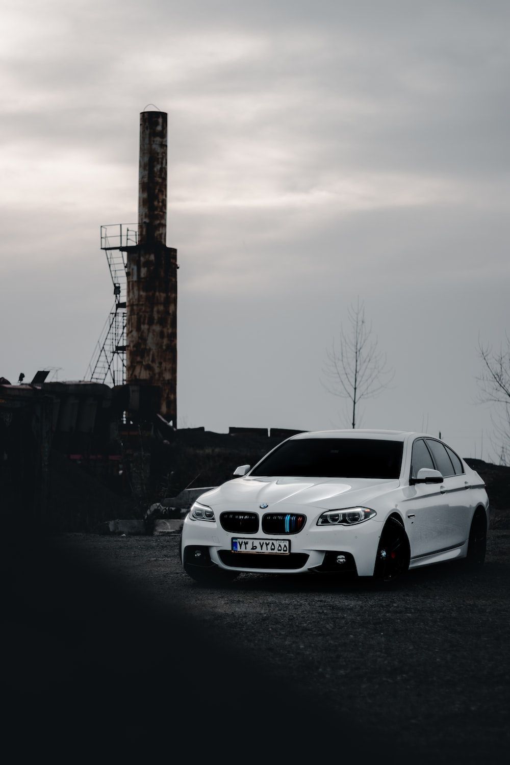 1000x1500 A white car parked in front of a