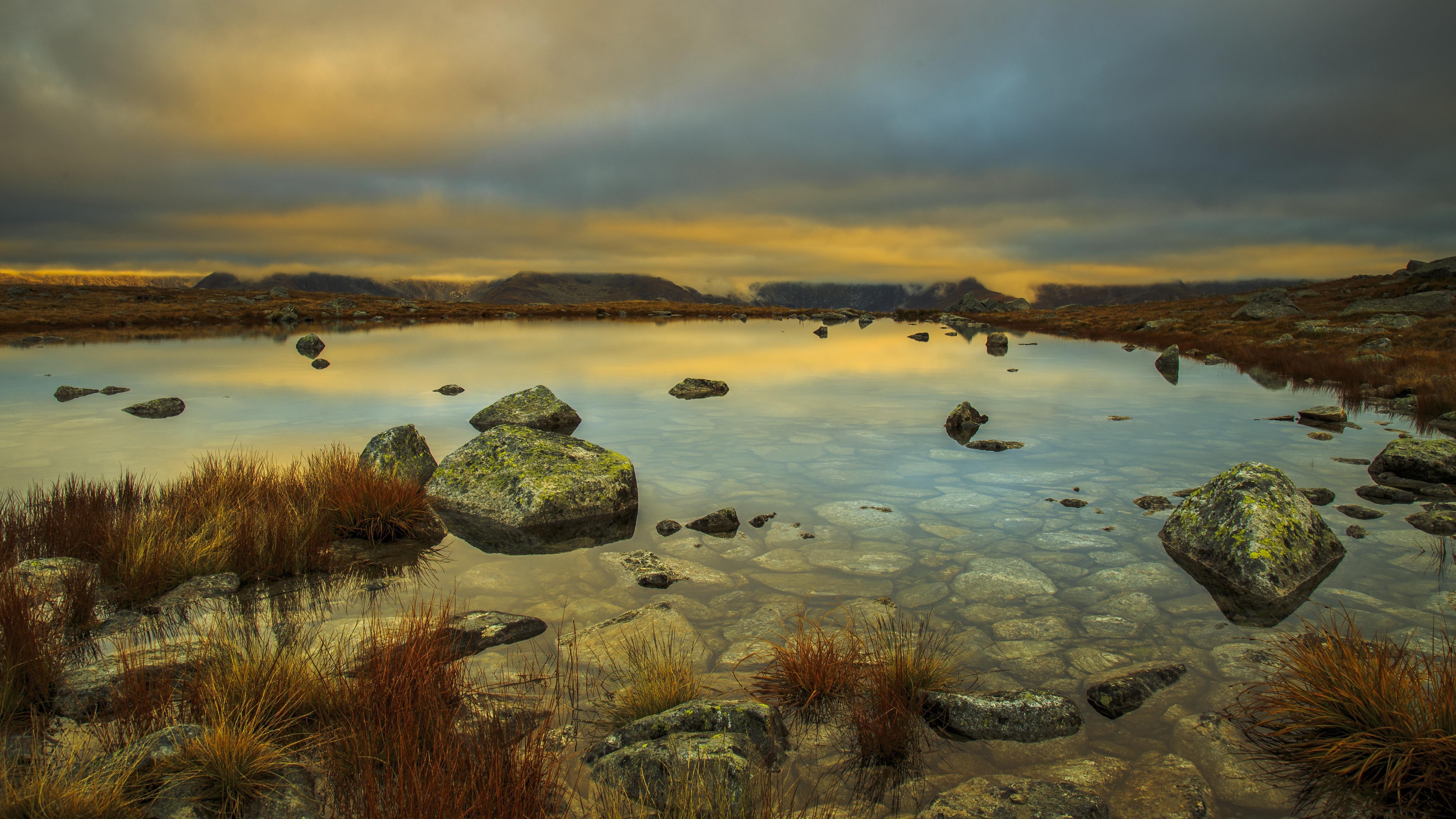 5465x3074 Mountain Lake Rocks Clouds Desktop Wallpaper
