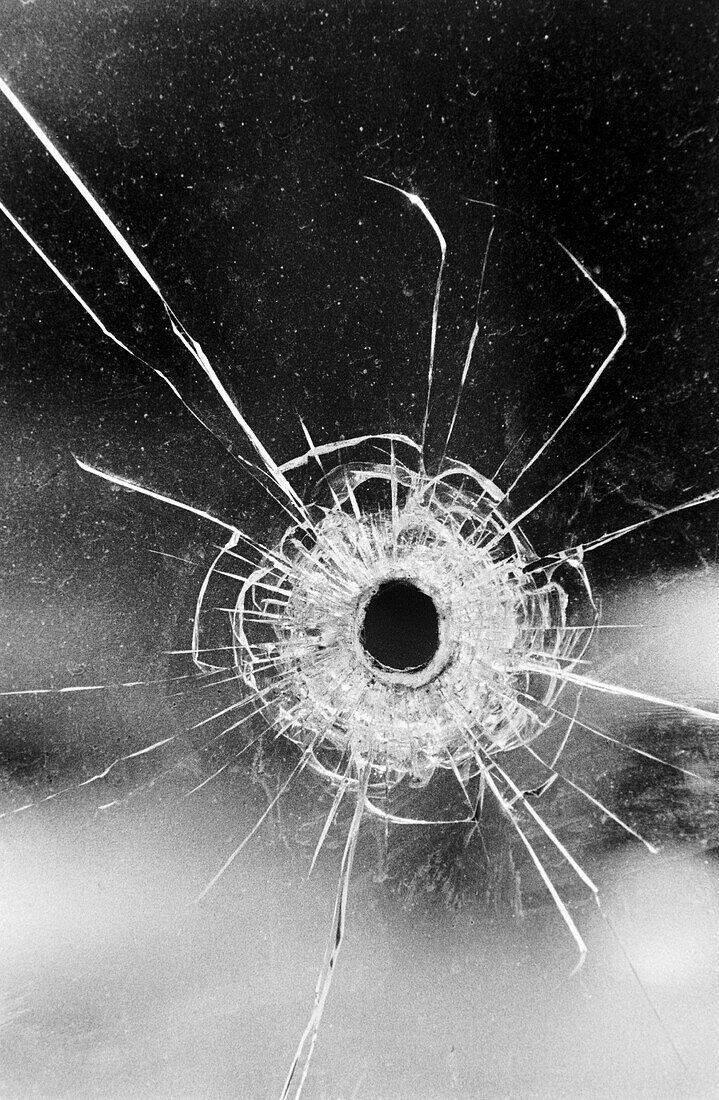 719x1100 Bullet hole in glass