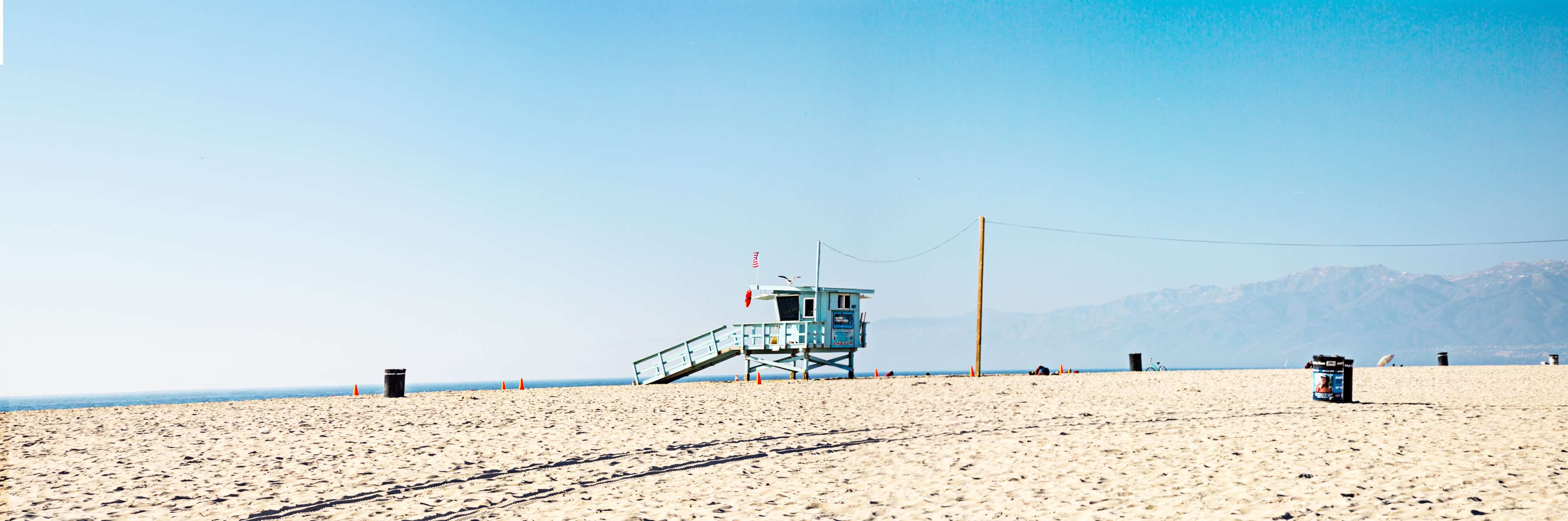 3589x1192 blue sky, california, life guard, mountains, ocean