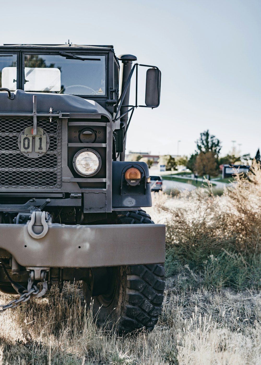 1000x1400 Grey military truck on green bush photo
