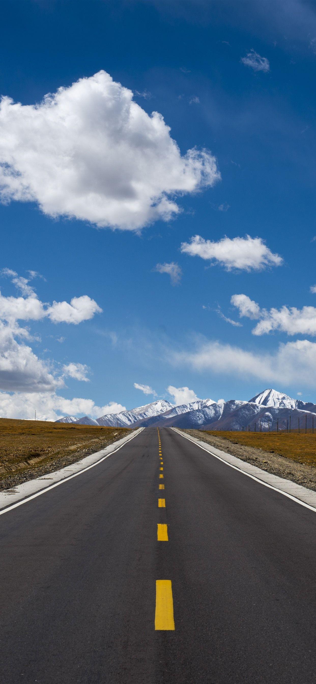 1242x2688 Tibet, road, snow mountains, clouds, blue sky 1242x2688
