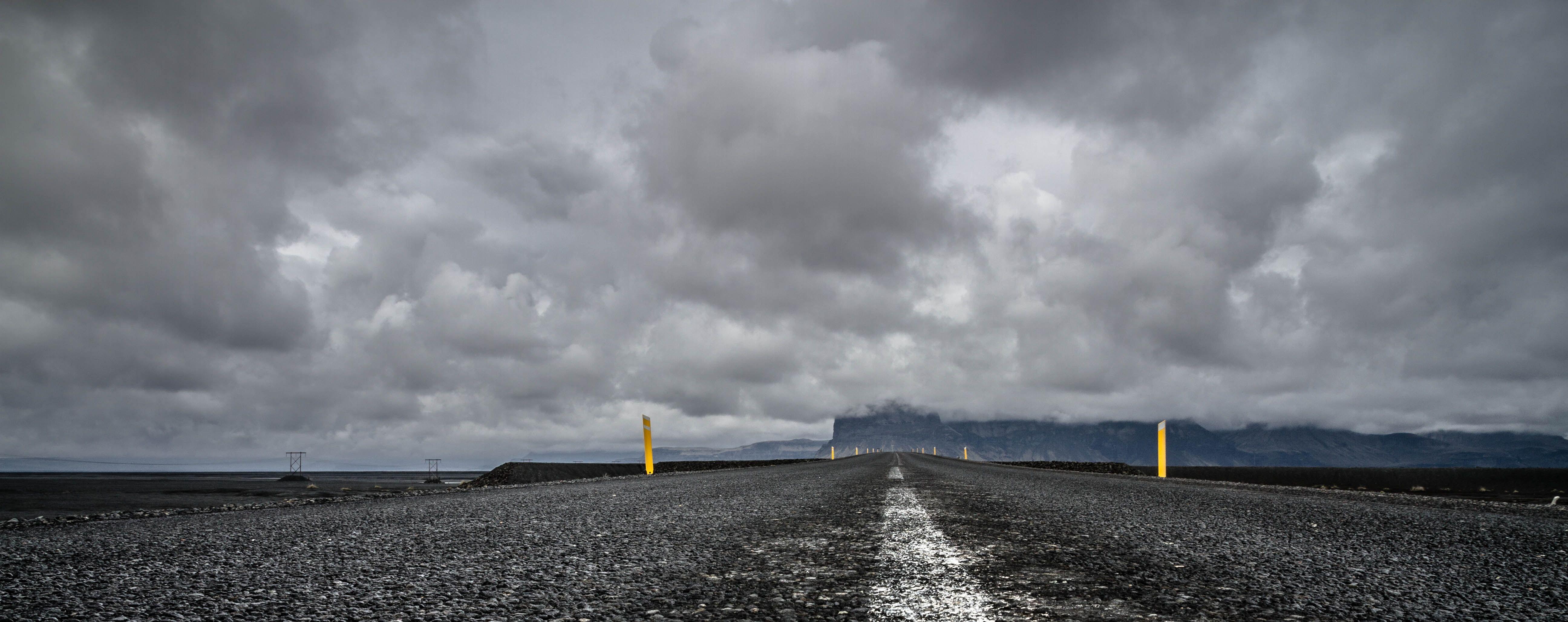 5184x2056 Gray road under dark cloudy sky during daytime HD wallpaper