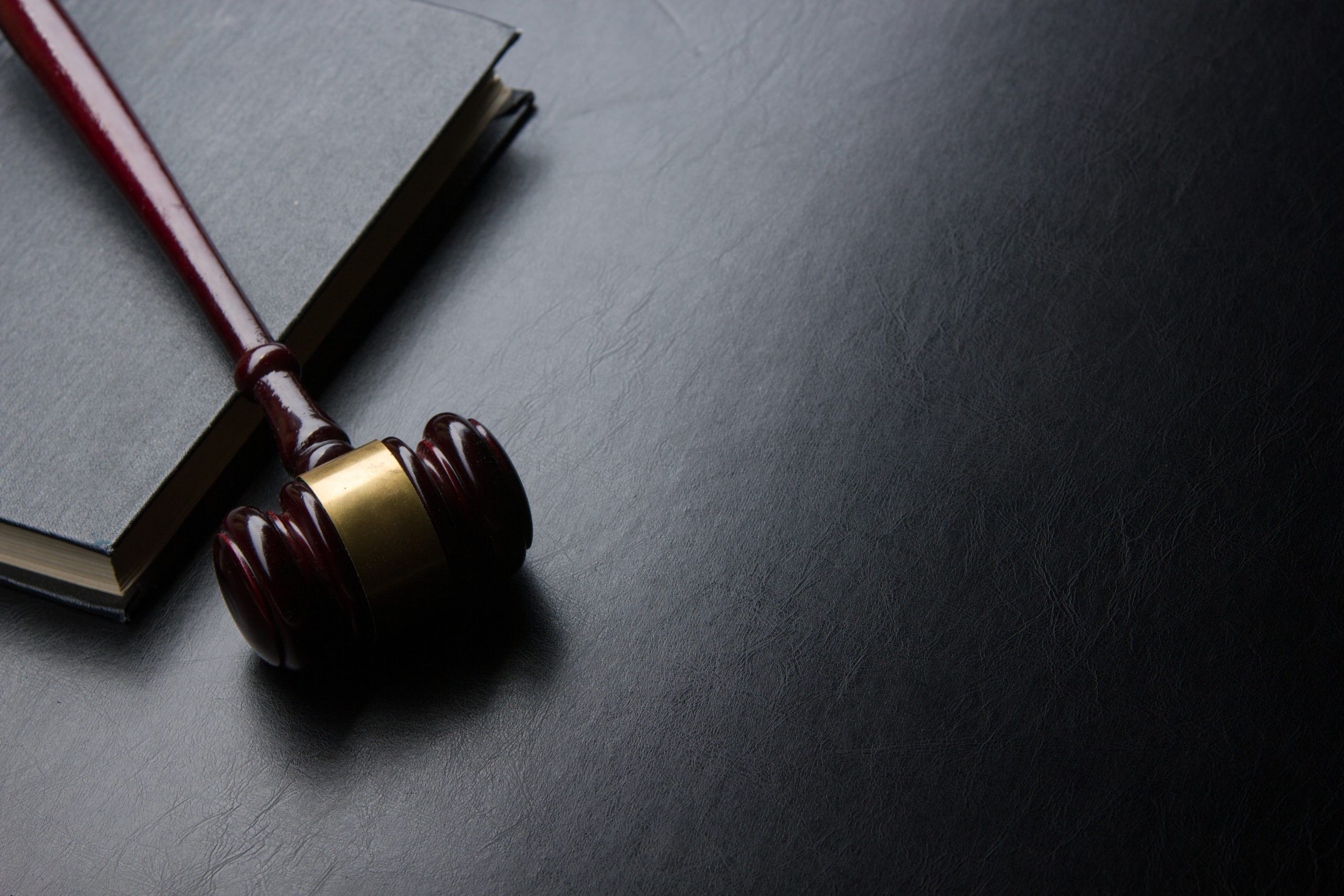 2560x1707 law book with a wooden judges gavel