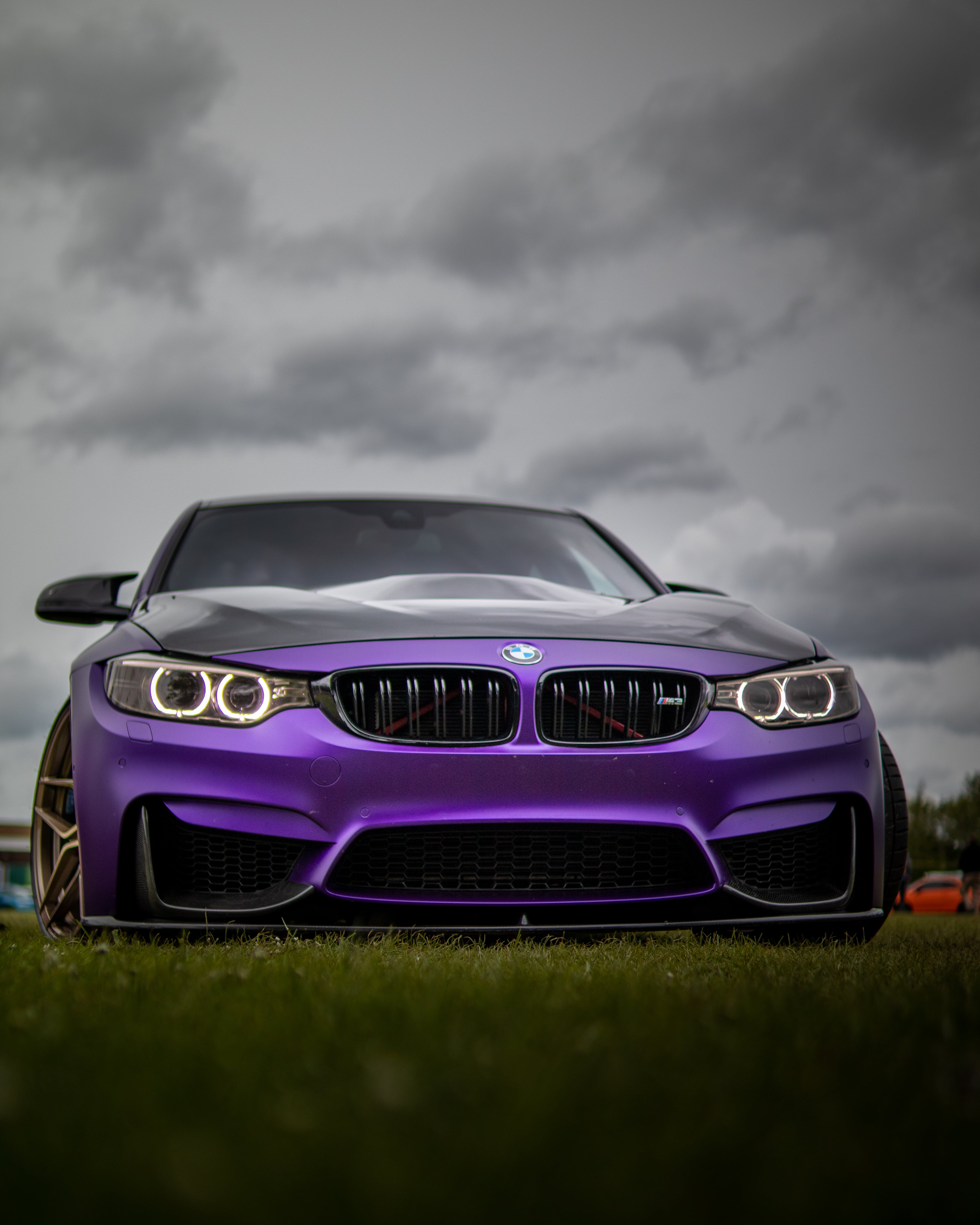 4000x5000 A Purple Bmw On Grass Under Dark Clouds