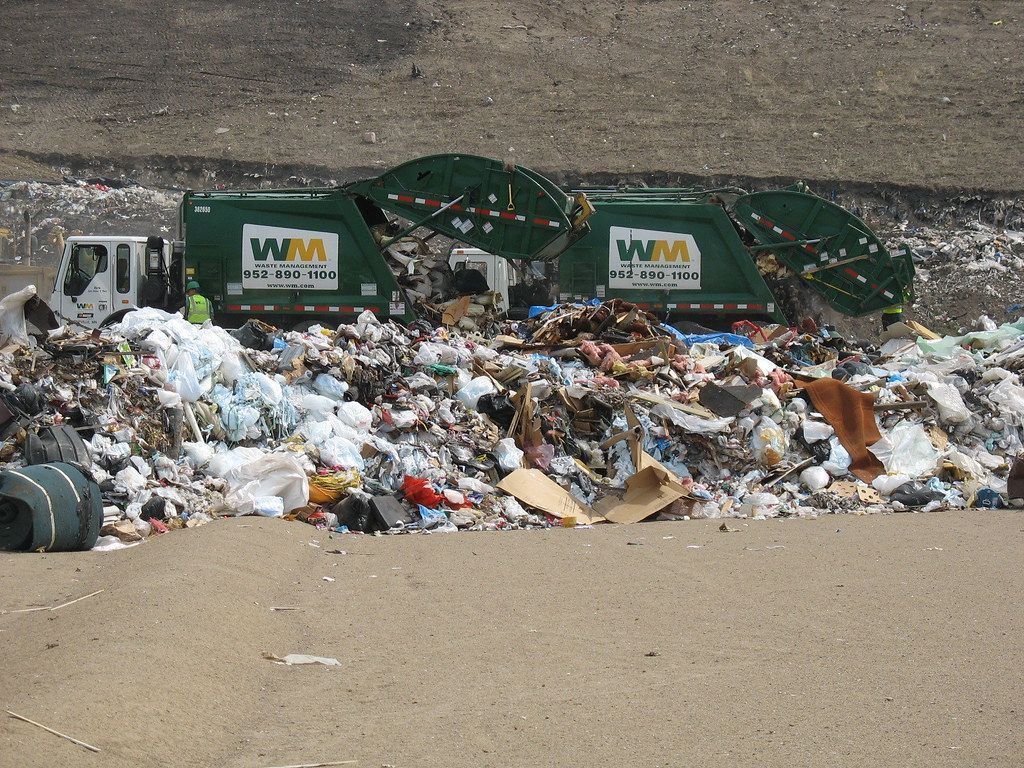 1024x768 Residential garbage trucks dumping a
