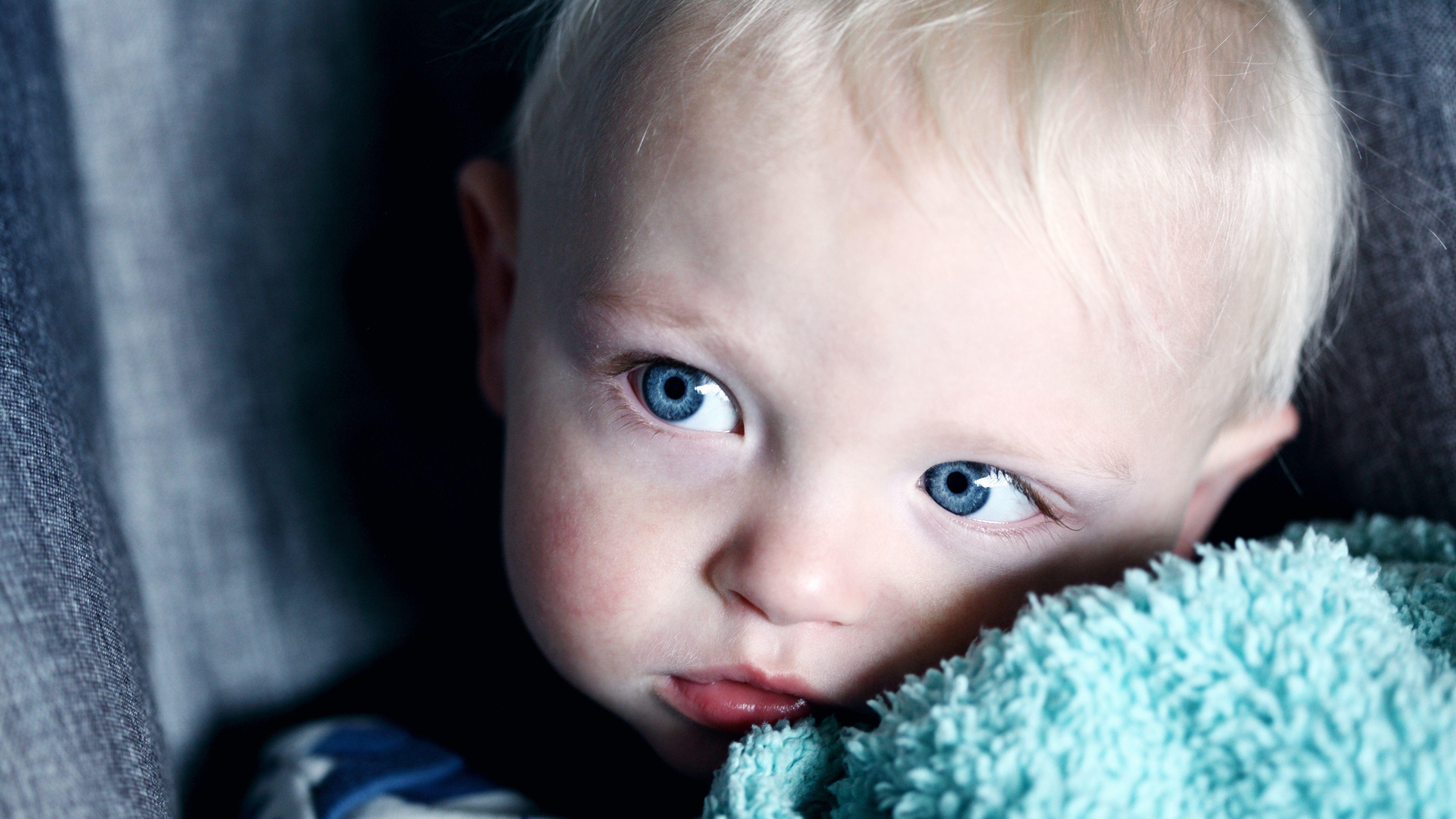 5616x3160 Delightful Baby Boy with Blue Eyes 5K Wallpaper