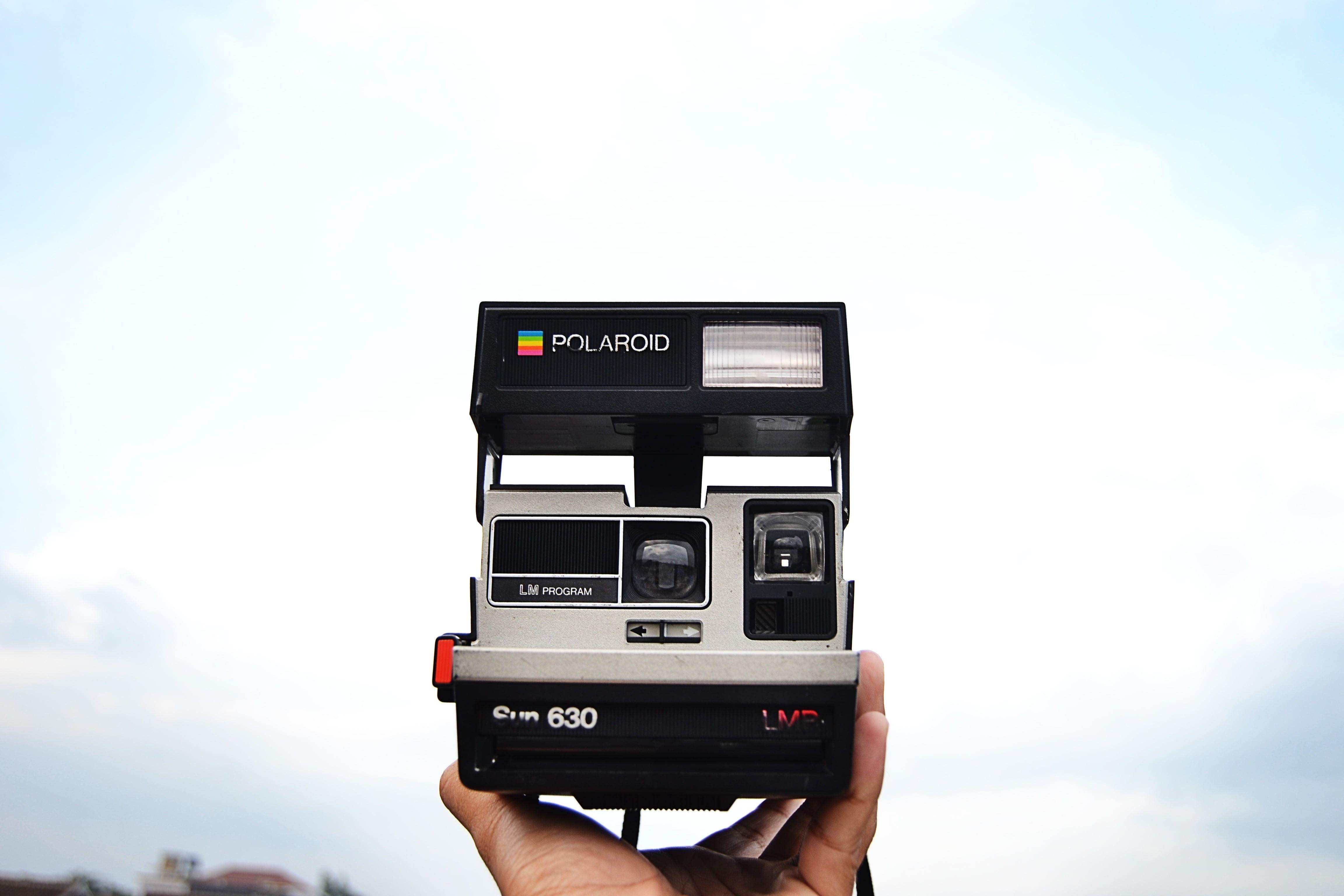 4608x3072 Person holding black and gray Polaroid instant camera HD