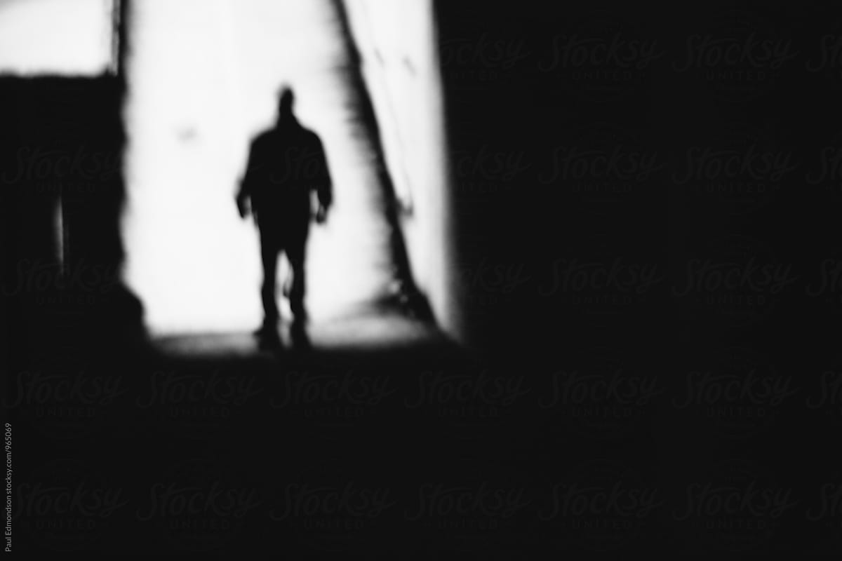 1200x800 Blurred view of man walking down dark alley