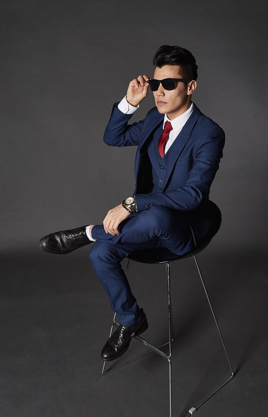 910x1413 HD wallpaper: man sitting on chair while holding sunglasses