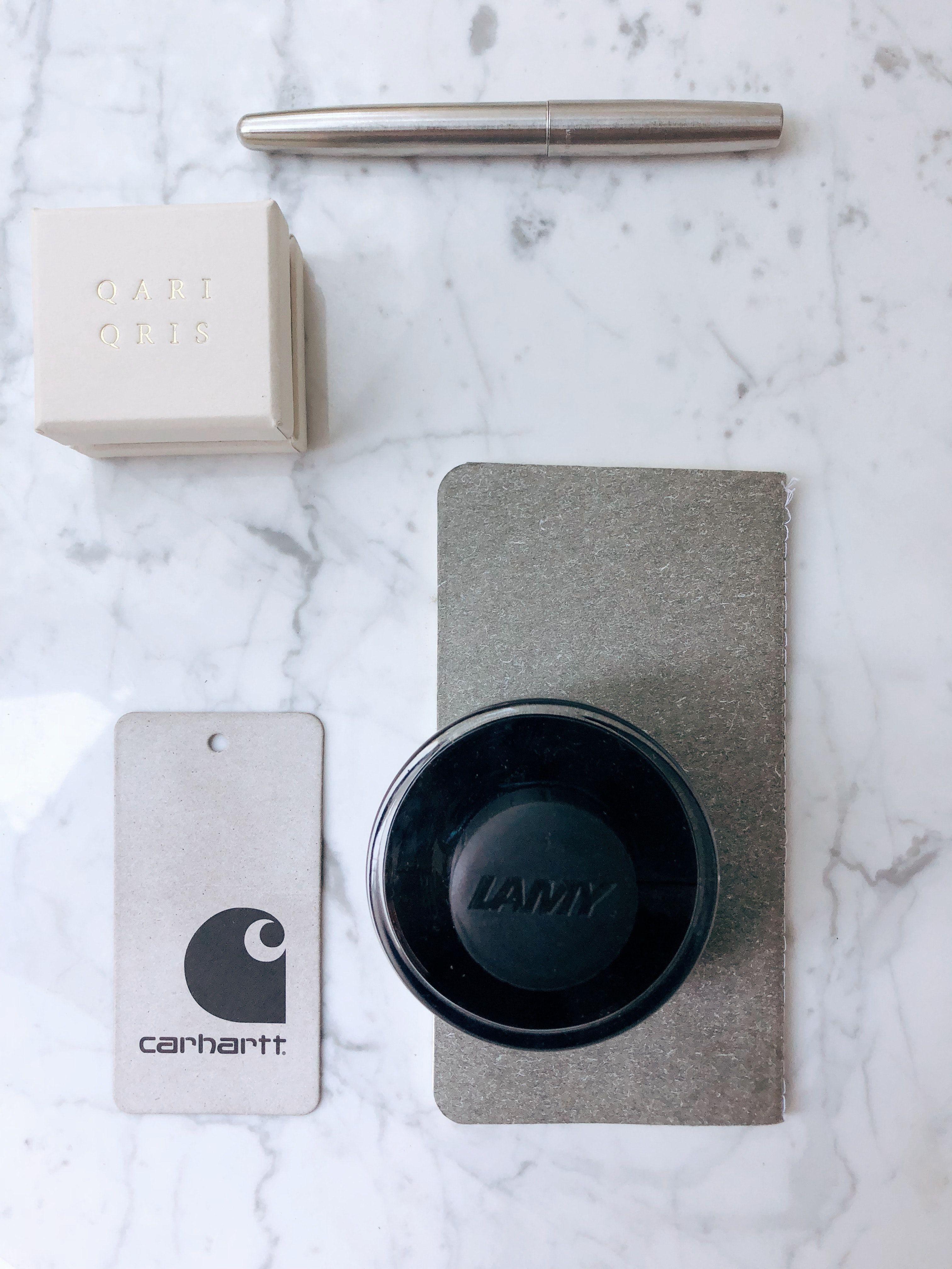 3024x4032 Carhartt Price Tag Beside Lamy Container on Marble Slab