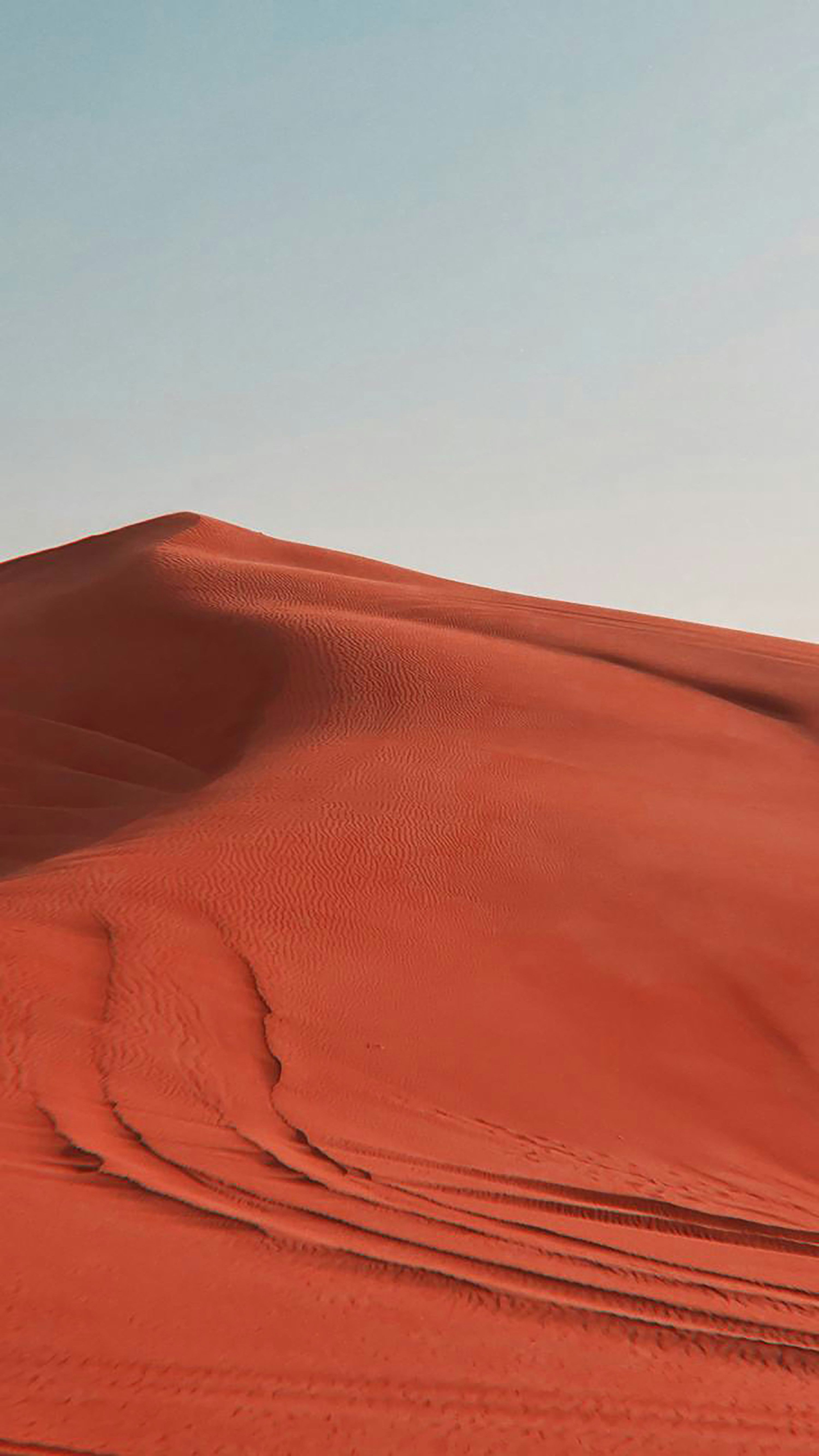 3000x5333 A person walking across a large red