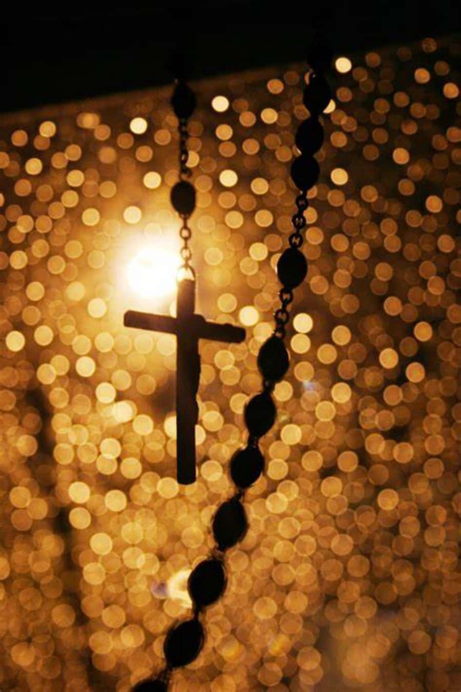 900x1350 Download Catholic Phone Rosary Bokeh Angle Shot Wallpaper