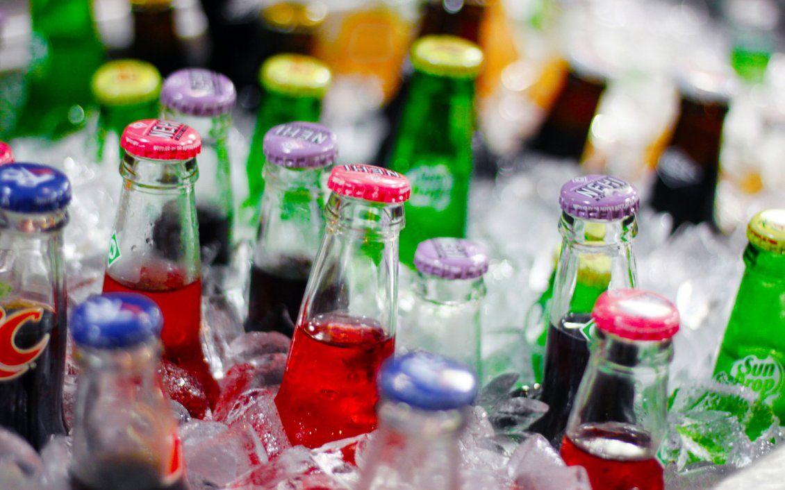 1130x706 Bottles of soda in the ice drink in a summer hot day